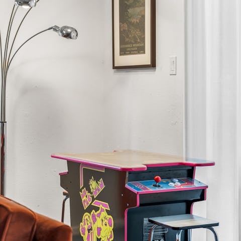 Play the arcade game in the TV room after a walk to the lake