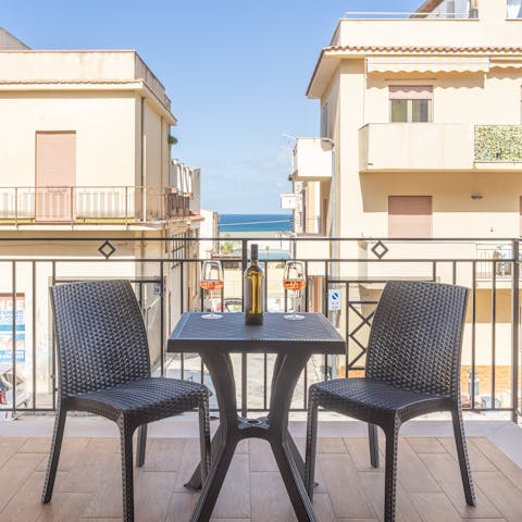 Watch the sun set over the sea from the private balcony