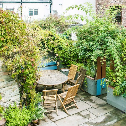 Sit in the lush garden with an iced tea