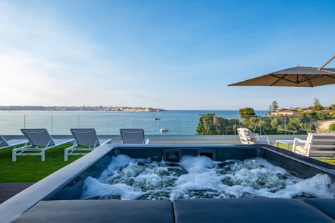 Bubble away in the hot tub as the bay stretches out ahead