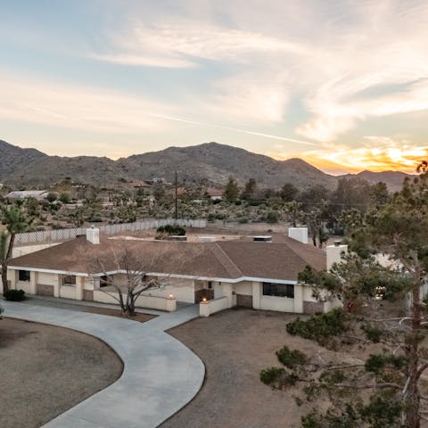 Watch as the sun sets over the mountains behind the house