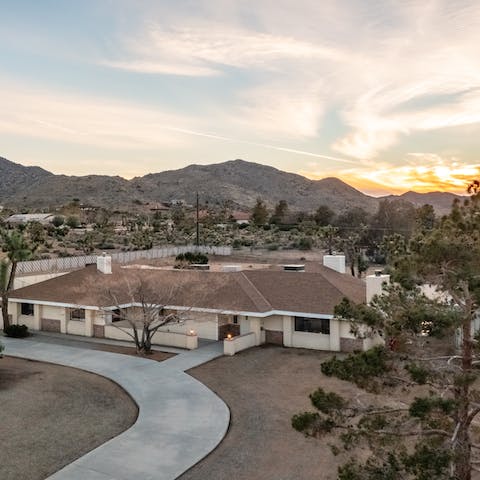 Watch as the sun sets over the mountains behind the house