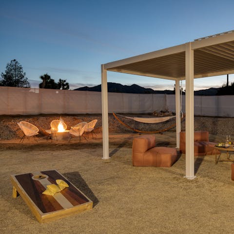 Enjoy the garden day or night, with outdoor games, a covered seating area, hammock and a fire pit