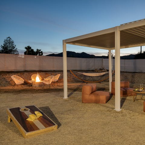 Enjoy the garden day or night, with outdoor games, a covered seating area, hammock and a fire pit