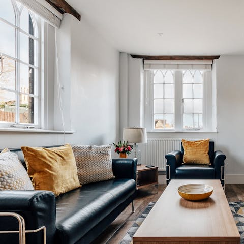 Relax in the living room with morning light streaming through the windows on either side