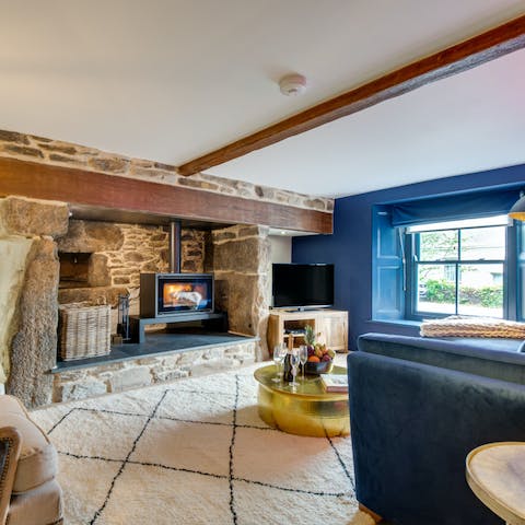 Snuggle together on the sofa close to the crackling wood burner