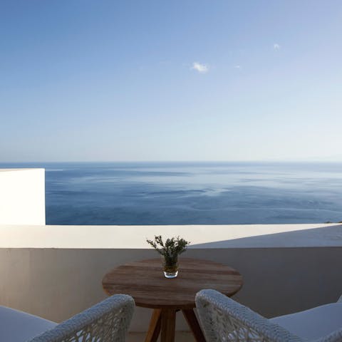 Sip sundowners as you gaze over the ocean from your balcony