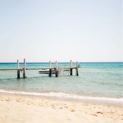 Walk 400m to a sandy beach for a day of paddling and sunbathing