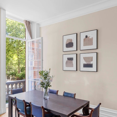 Gather around the dining table overlooking the leafy streets