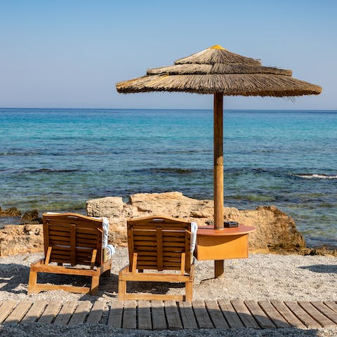 Drive to Afandou beach and enjoy azure waves lapping at the Mediterranean shore