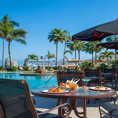 Sip on a cocktail and bite on some tasty tacos by the pool
