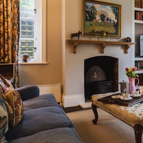 Gather round the ornate fireplace for a cosy evening in