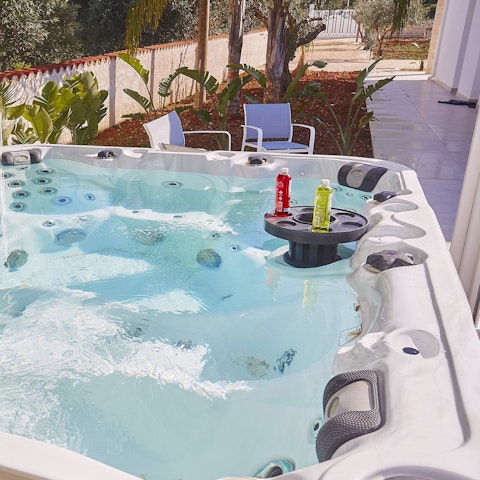 Jump in the Jacuzzi and relax with a glass of wine