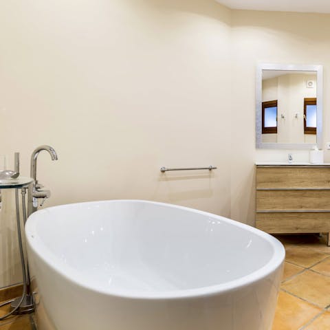 Enjoy a sublime soak in the freestanding bathtub after long days exploring the island