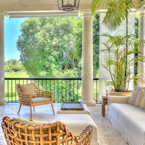 Gaze out over the verdant surroundings from the shady verandah