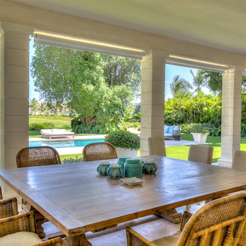 Gather around the table on the terrace and enjoy dinner cooked by the home's private chef