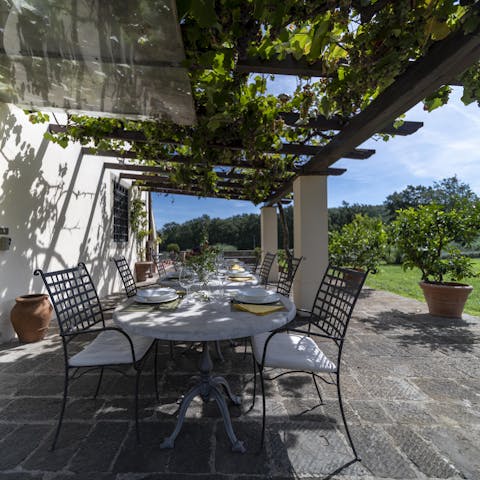 Get together under the vine-covered pergola to enjoy a meal alfresco