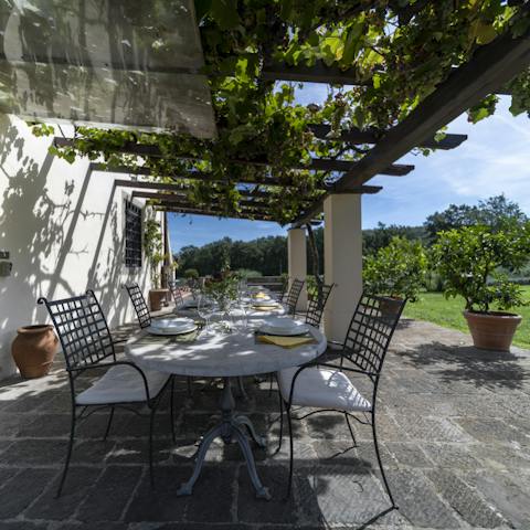 Get together under the vine-covered pergola to enjoy a meal alfresco