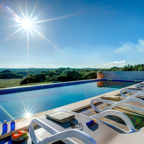 Unwind poolside beneath blue skies following a 9km cycle to Maó