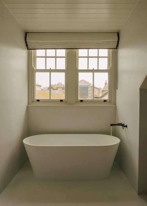 Sink into the freestanding tub for a soak after a morning surf