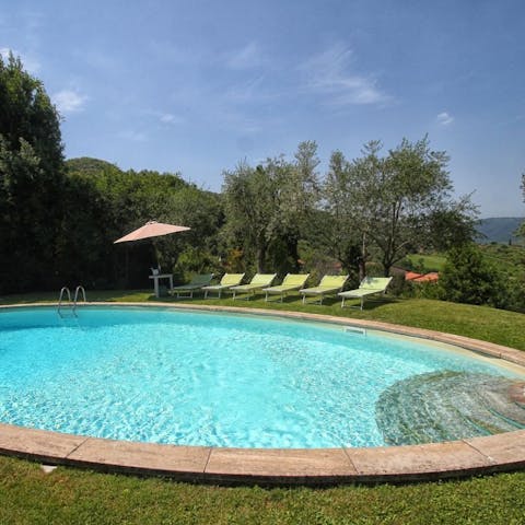 Settle back on a lounger by the pool