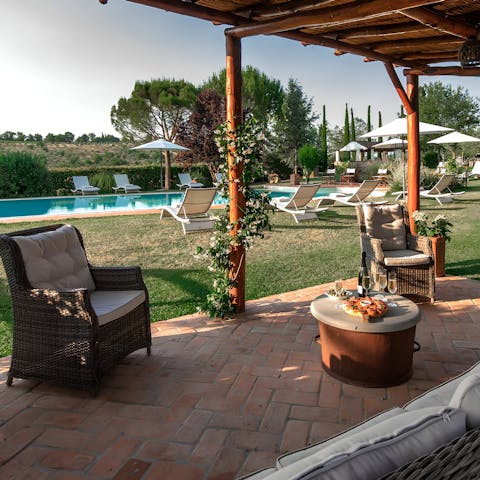 Enjoy sunset drinks on the covered patio overlooking the pool