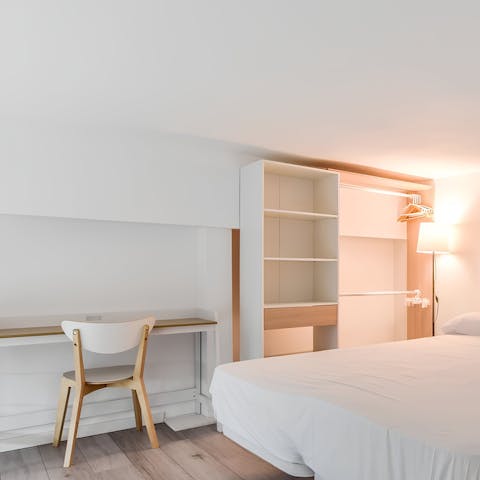 Catch up on emails from the bedroom's handy workspace