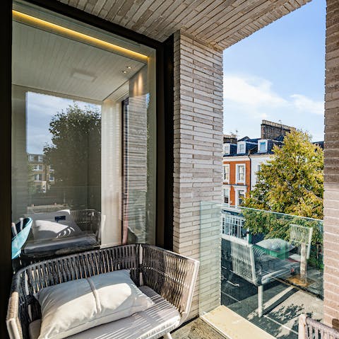 Sit on the balcony with a cup of coffee (or a few cocktails) and watch the world go by