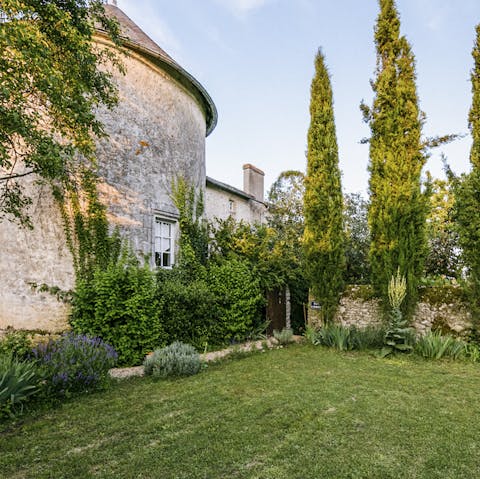 Extensive picturesque gardens enclosed by a medieval stone wall