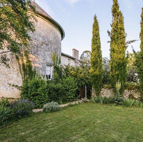 Extensive picturesque gardens enclosed by a medieval stone wall