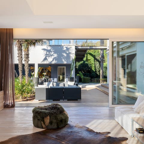Slide open the glass walls, instantly extending the living space outdoors