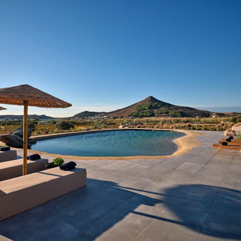 Slip into the lagoon-style swimming pool and dry off on a lounger