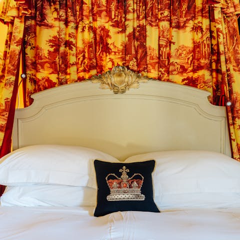 Relax in the romantic bedroom with its antique French bed and fabulous, gilded canopy in a dramatic toile fabric