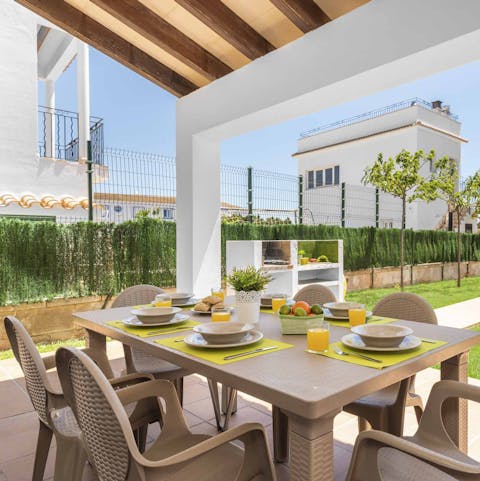 Tuck into delicious barbecue feasts around the dining table on the covered terrace