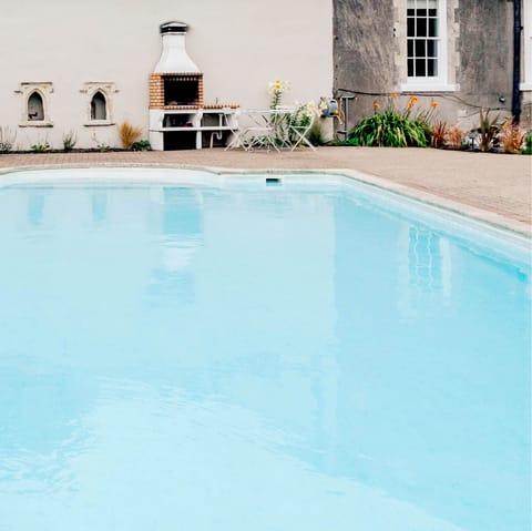 Take a dip in the enormous outdoor swimming pool