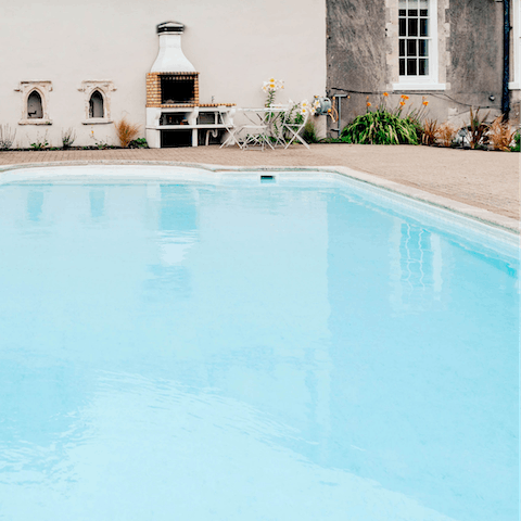 Take a dip in the enormous outdoor swimming pool