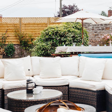 Socialise out on the poolside patio on a sunny day