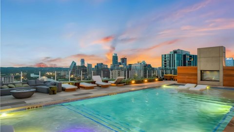 Swim above the Austin skyline as the sun goes down