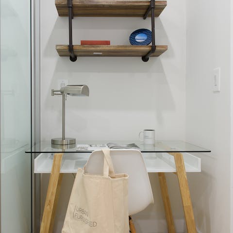 Catch up on emails at the chic glass desk