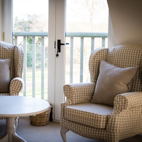 Curl up with a good book and look at the view from the French doors