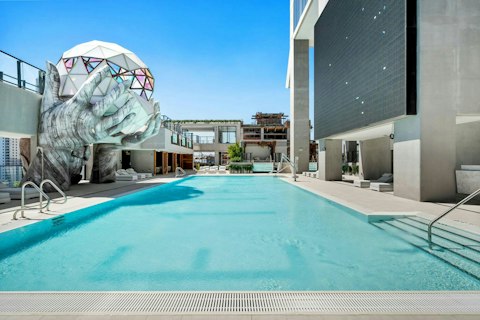Cool off in the shared pool beneath the Miami sky