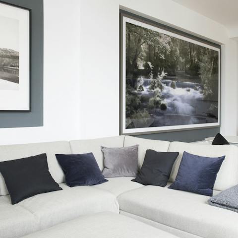 Cosy up with a glass of wine in the L-shaped couch at the end of an exiting day in the city