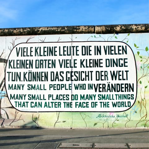 Admire the art of the East Side Gallery, a fifteen-minute walk away