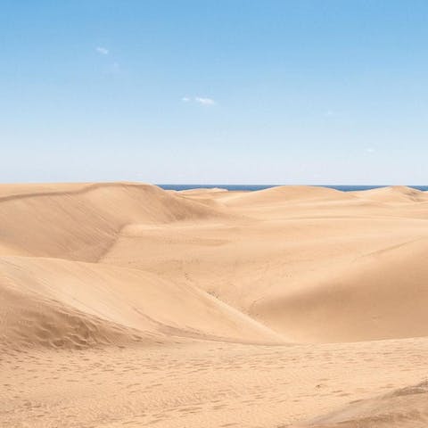 Take a stroll over the sand as you head to the sea at Dunas de Maspalomas