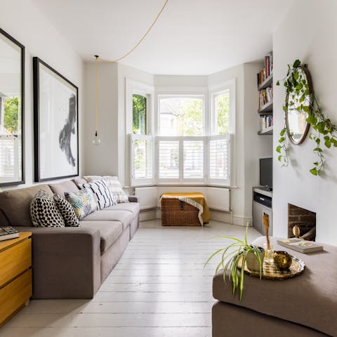 Relax in the bright living area with a mug of Earl Grey and a book from the shelves