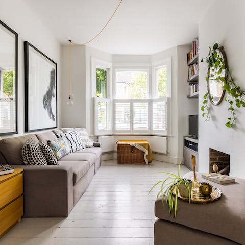 Relax in the bright living area with a mug of Earl Grey and a book from the shelves