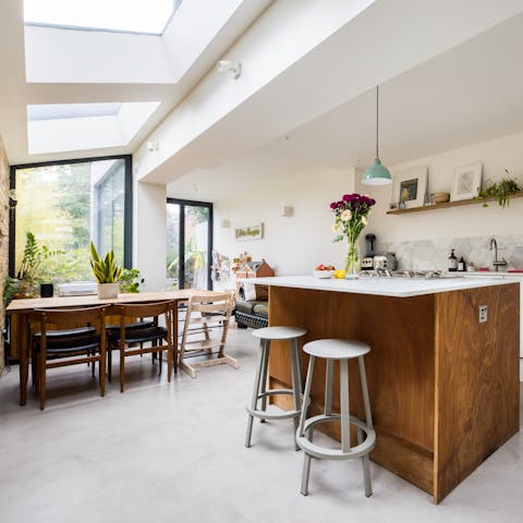 Enjoy a bite to eat at the sociable breakfast bar or around the dining table with its ceiling windows