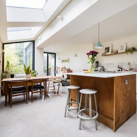 Enjoy a bite to eat at the sociable breakfast bar or around the dining table with its ceiling windows
