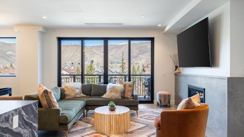 Unwind by the fire as mountain peaks fill the window