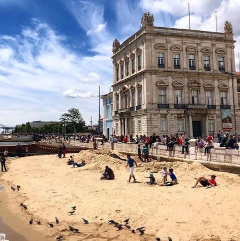Sunbathe on the banks of the Tagus River along Cais das Colunas, just a six-minute walk away